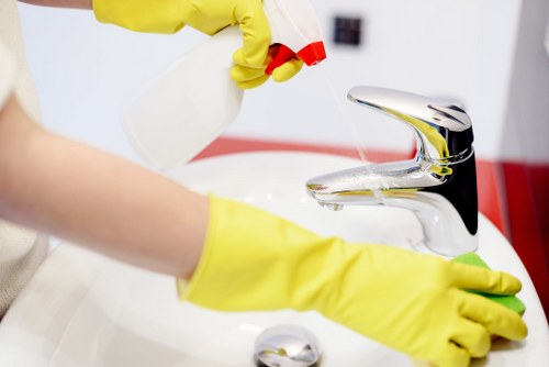 Local technician cleaning a corner sofa in Lambeth